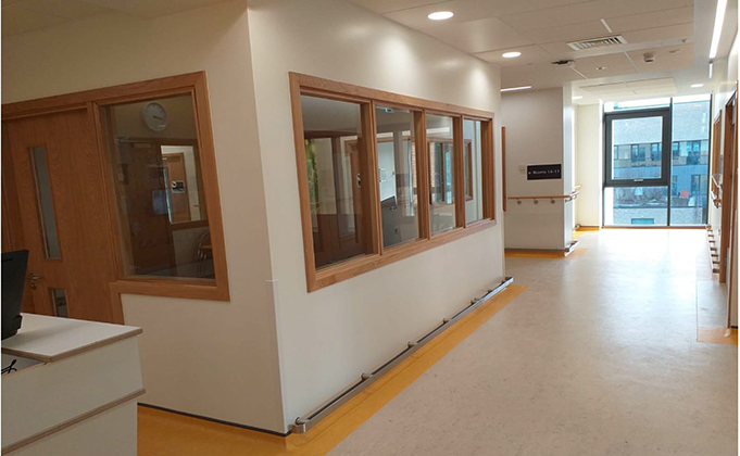 Timber glazed screens and doorset into reception area in clinic