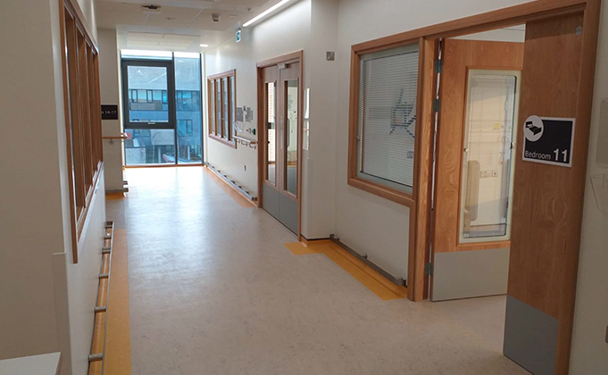 healthcare corridor with timber doorsets and side screens