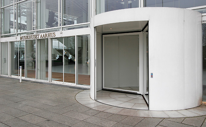 classic white framed revolving door entrance to building