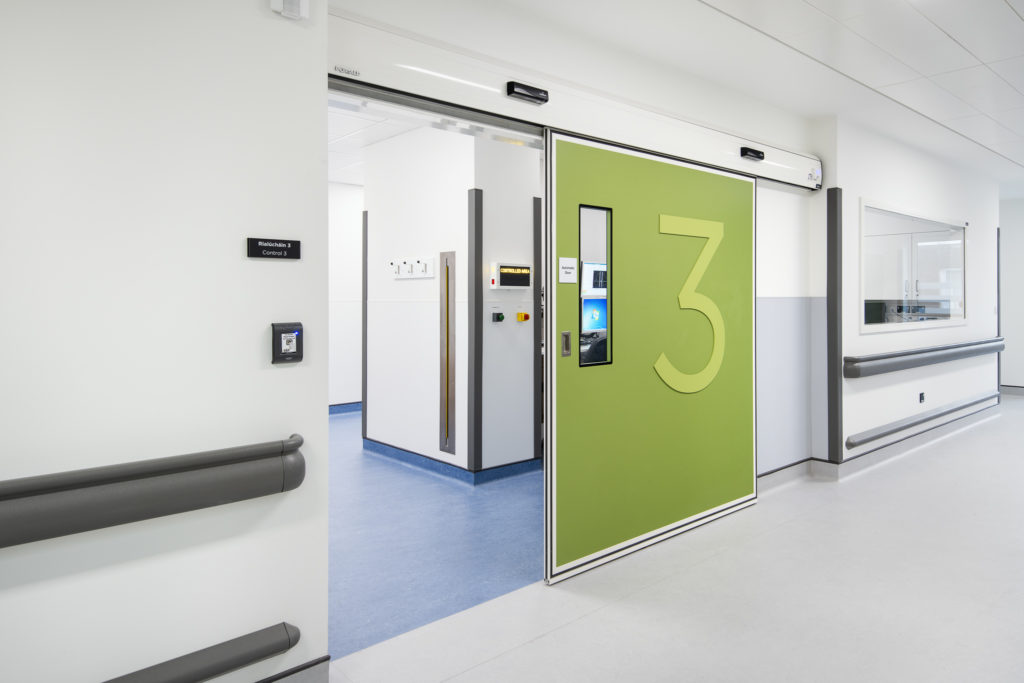 Green clean room doors with a number 3 opening up to a hygienic environment