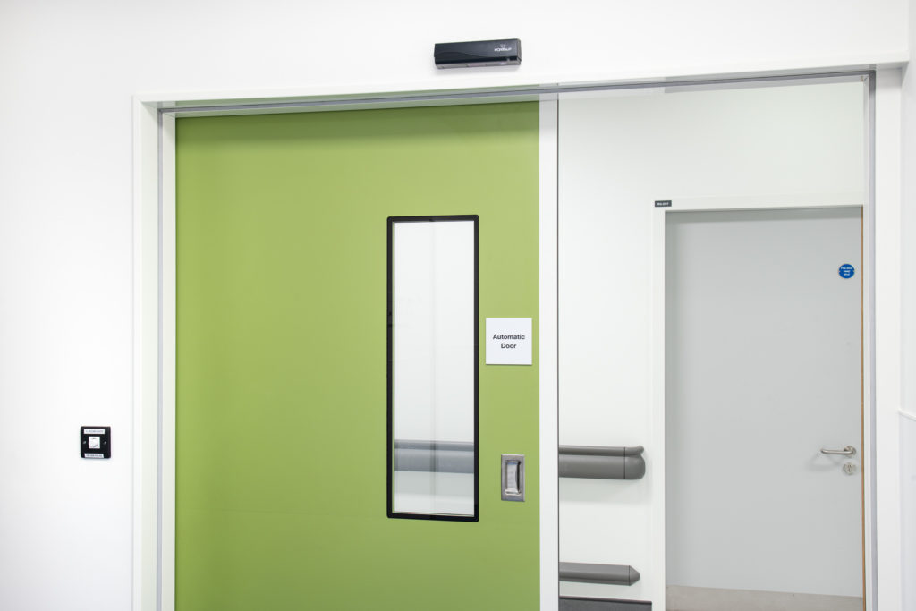 Cleanroom doors in green with integrated vision panel