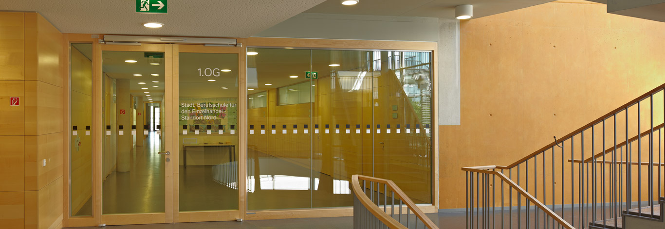 Glazed Automatic swing door with integrated surrounding glazed screen installed off a circulation stairwell area