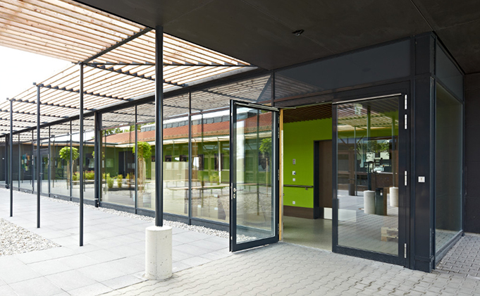 Black framed automatic glazed swing entrance doorsets with integrated surrounding glazed screen