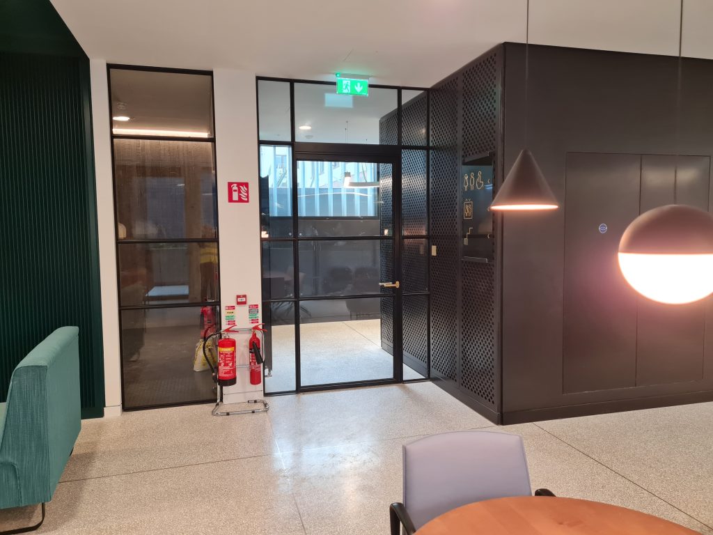 Glass door with slim steel profiles in modern office building