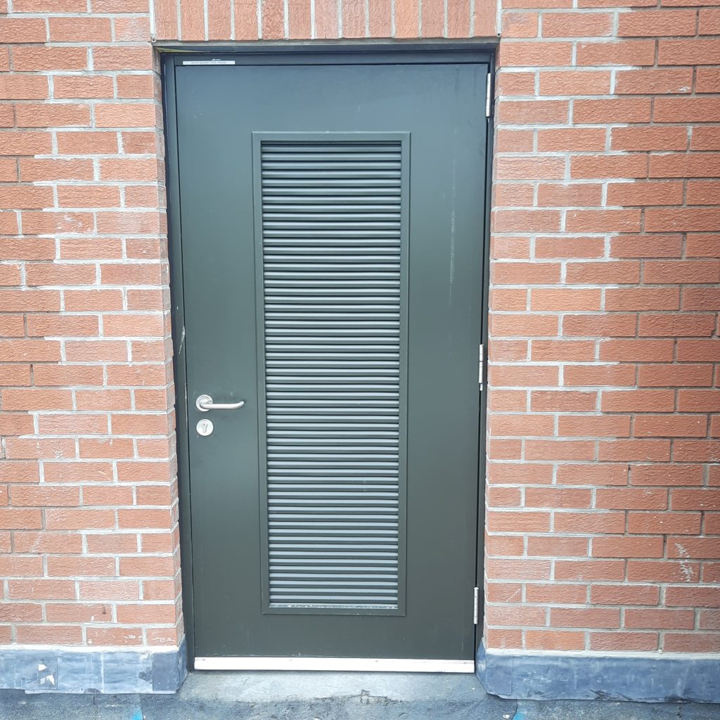 close up of external steel door on plant room with louvred feature