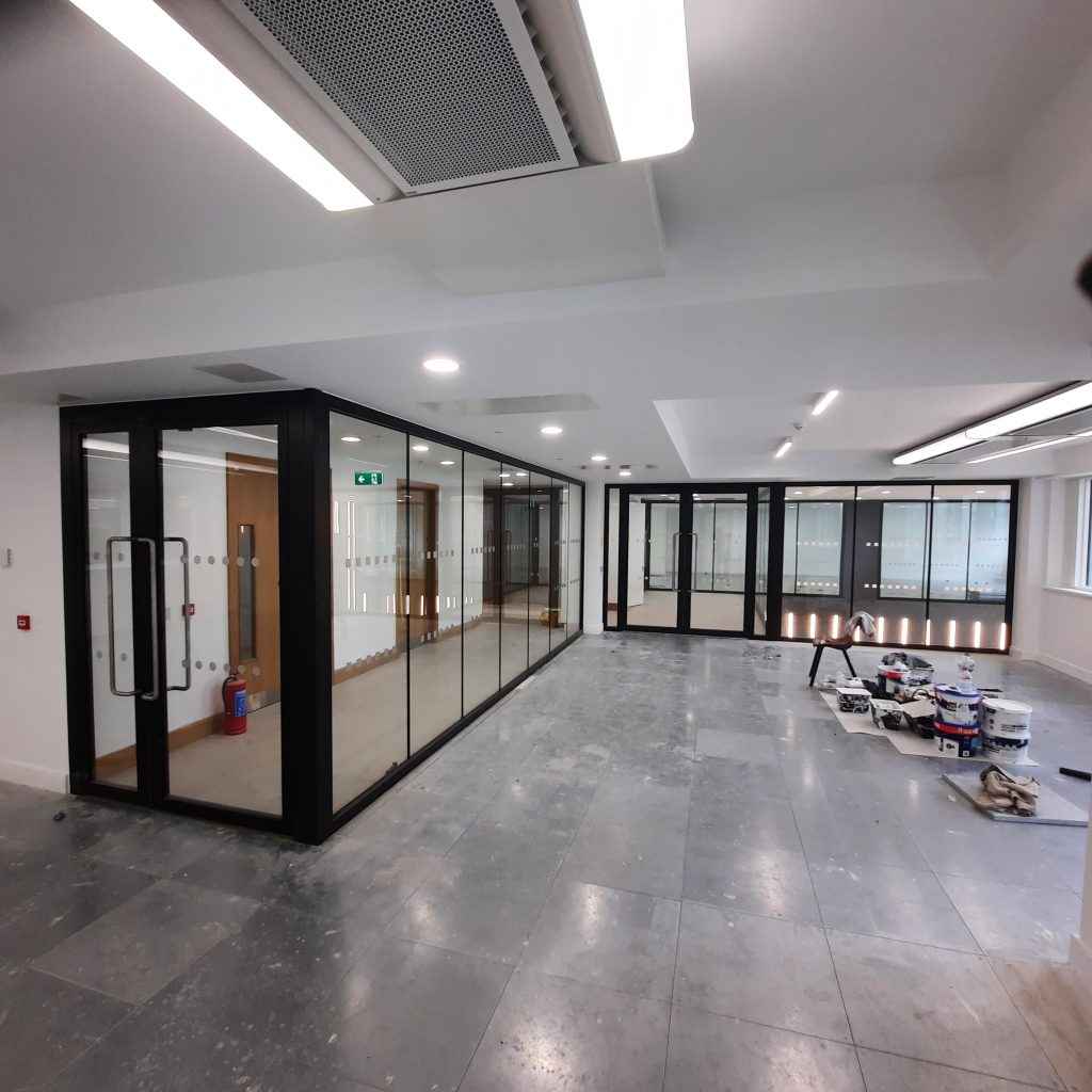 modern office space with glass wall and door to enter and exit