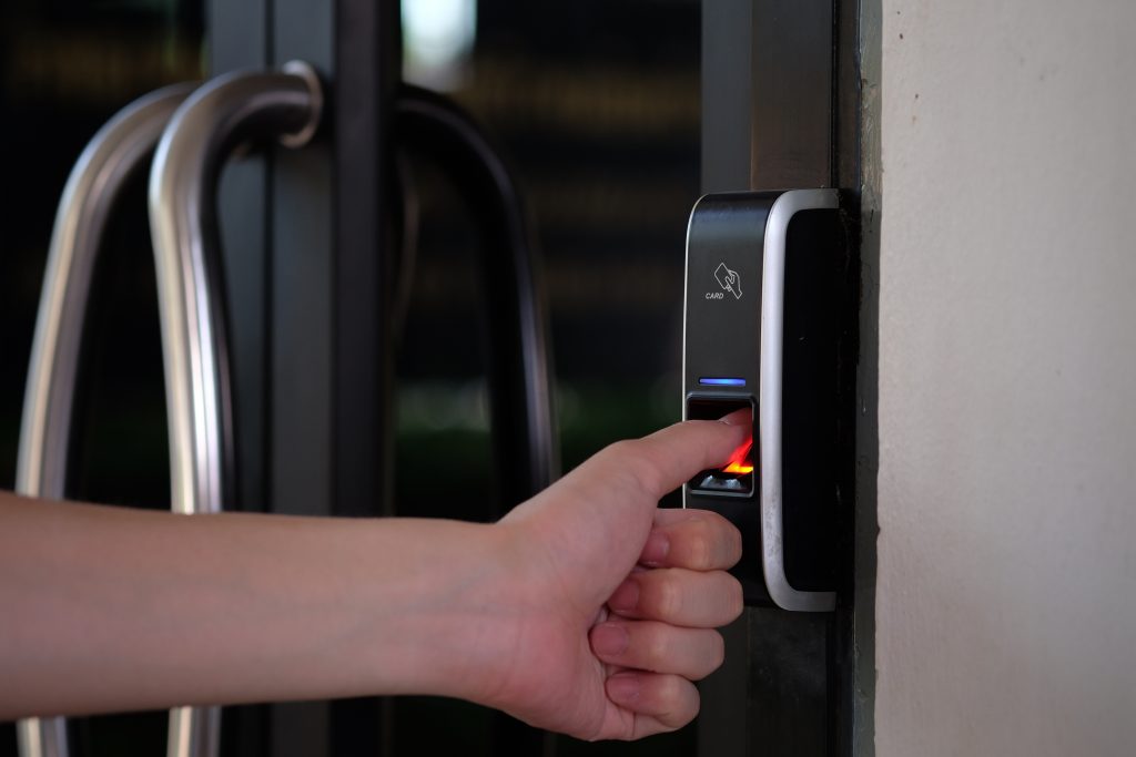 Fingerprint biometric access control reader at entrance to building