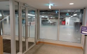 Steel glazed, automated doors at entrance to building from carpark