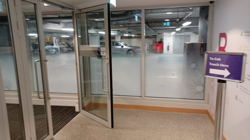 steel glazed door and glazed screens at entrance lobby from carpark