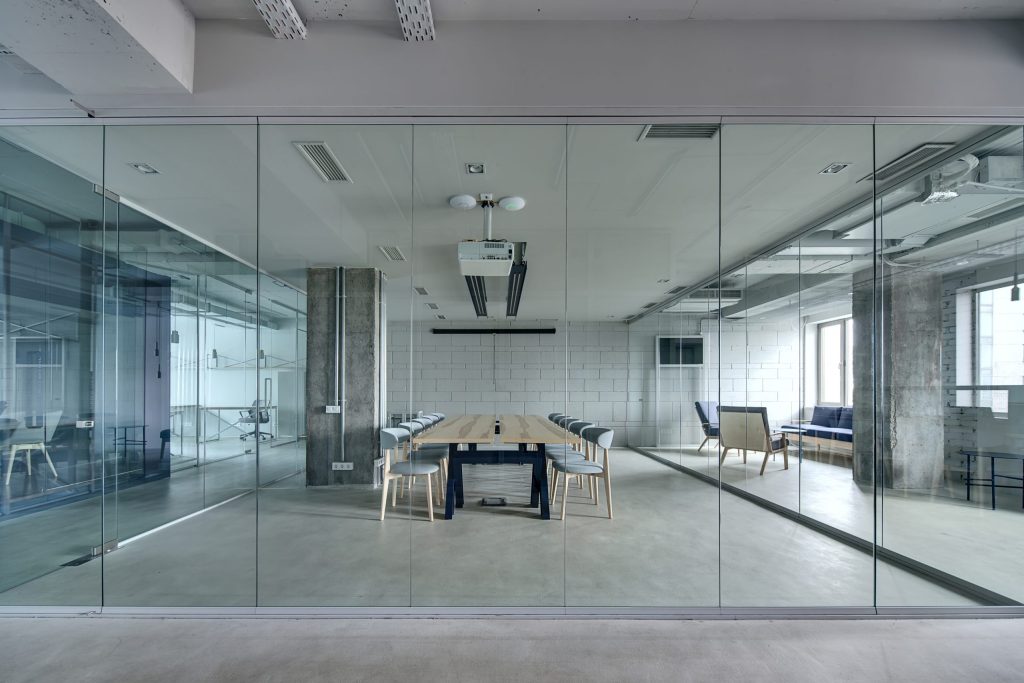 slim profile glass wall in office environment