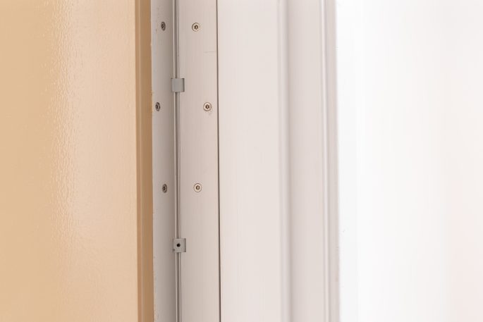 close up of top section of continuous geared hinge in mental health facility