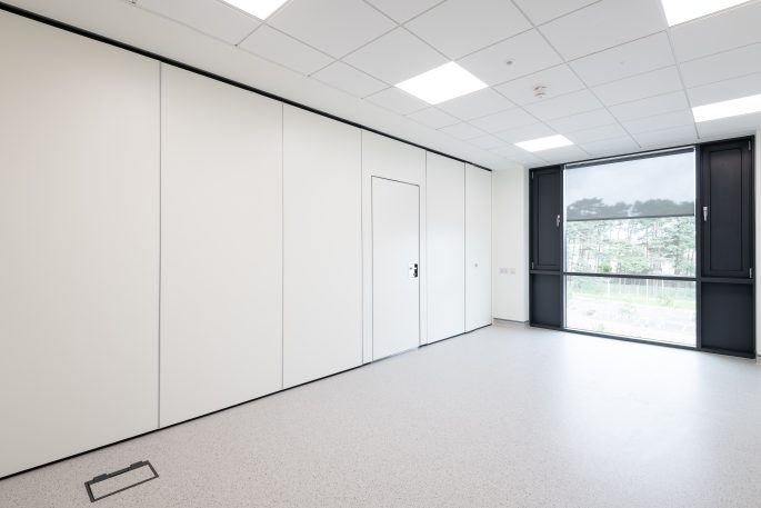 Office featuring a solid walls and partitions with integrated door panel. Wall can be folded back to open up the space fully.