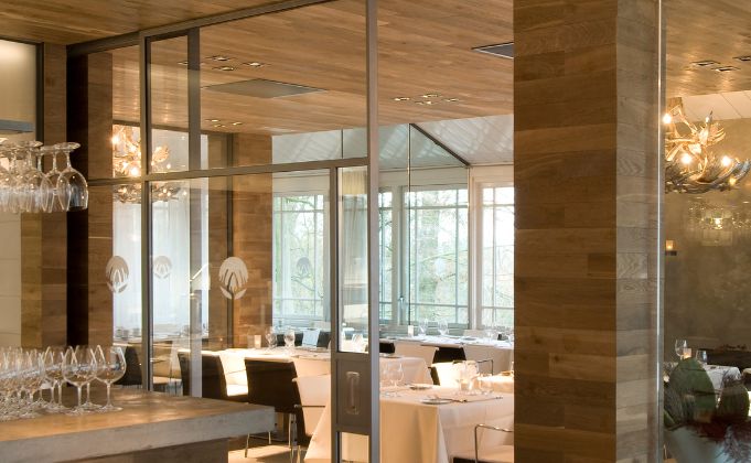 Internal steel door surrounded by glazed steel screens in modern restaurant
