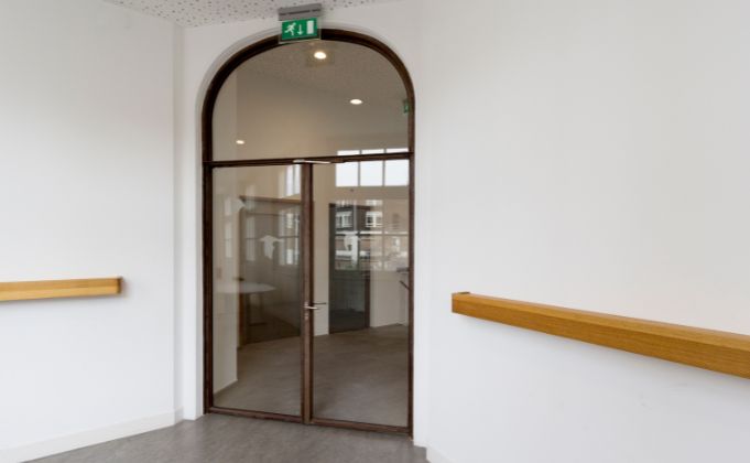 Interior double steel glass door with arched panel overhead