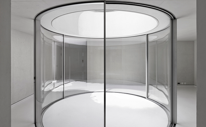 Curved glass doors by Sky-Frame as internal courtyard
