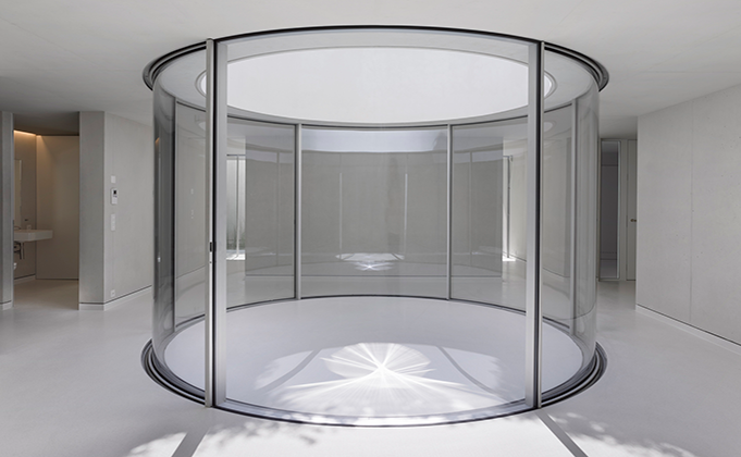 Curved glass doors surround internal courtyard area with roof light