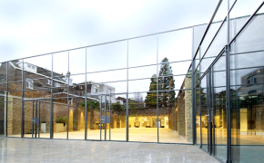Hinged glass doors on full glass facade of commercial building