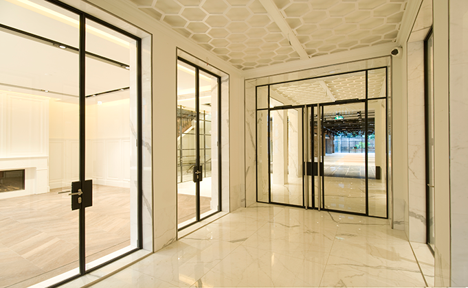 Internal hinged glass doors in luxury building with marble floors