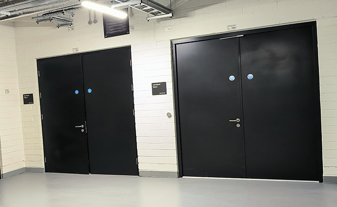 Double steel doors in black in basement of building
